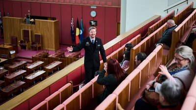 A guide shows visitors features of the Senate Chambers at Parliament House