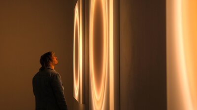 Visitor viewing wall artworks