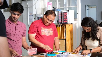 Visitors making glass tiles