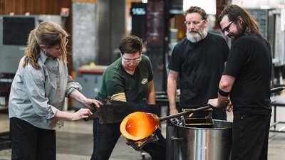 Artists glass blowing in the Hotshop at Canberra Glassworks