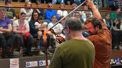 Two artists working with molten glass