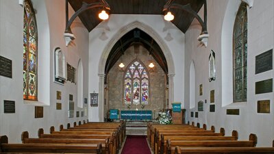 Interior of traditional stone church with stained glass windows