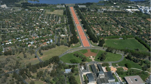 Mt Ainslie is a great starting point to  understand the layout of Australia's national capital Aerial view of buildings, grassed areas, long promenade and lake.