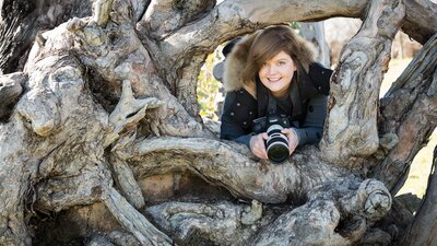 Photographer in an interesting tree trunk