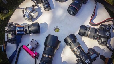 A range of digital cameras on a table