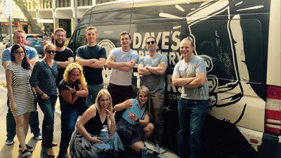 Beer tour participants in front of the Dave's Brewery Tour bus