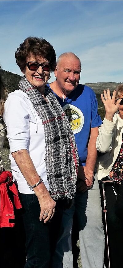 Four seniors and tour guide at Charlotte pass lookout with Mount Kosciuszko behind