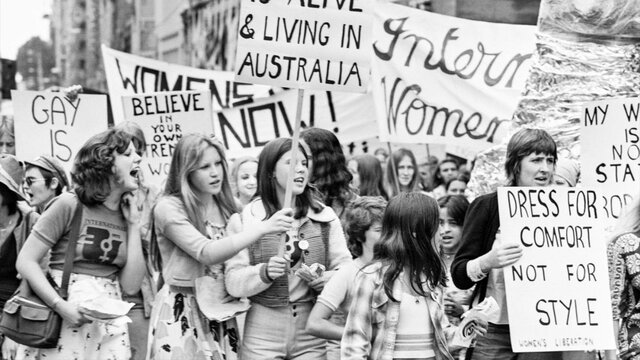 Black and white photograph of a group of people protesting at a march