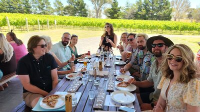 A group of persons having lunch at a winery
