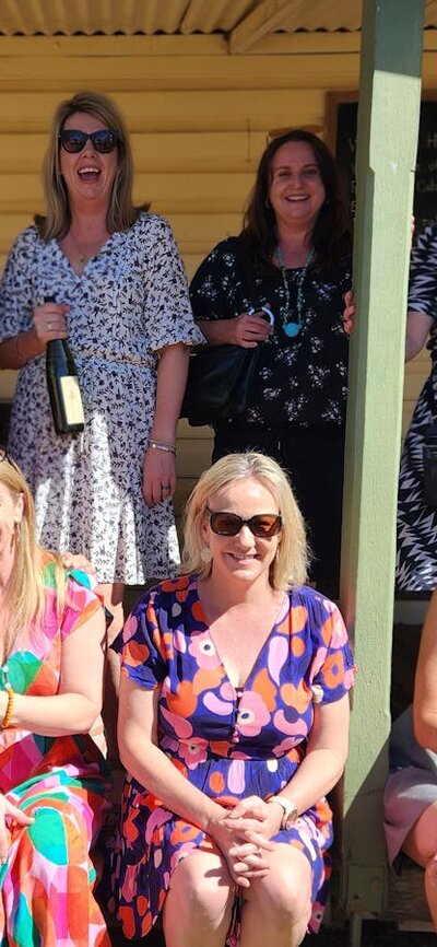 Group of lovely ladies posing with bottles of wine at Helm Wines