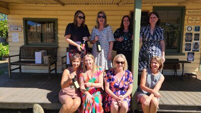 Group of lovely ladies posing with bottles of wine at Helm Wines