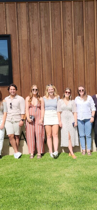 Group of friends posing for photo outside Shaw Wines on a Merry Heart CBR Great Tour