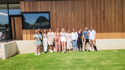 Group of friends posing for photo outside Shaw Wines on a Merry Heart CBR Great Tour