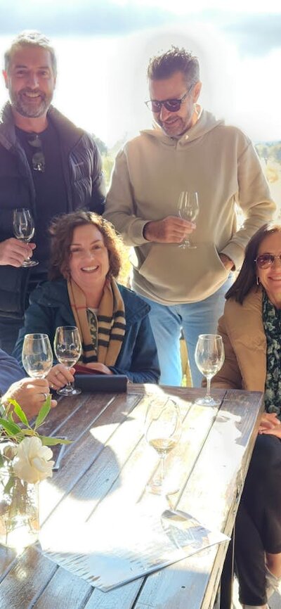 Group photo at the Vintner's Daughter with the vineyard in the background