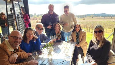 Group photo at the Vintner's Daughter with the vineyard in the background