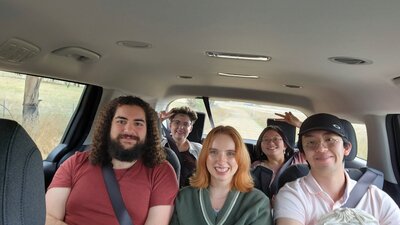 A group selfie in the vehicle