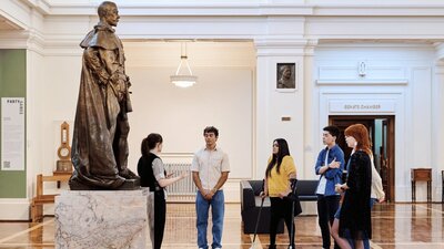 A group of people stand in King's Hall