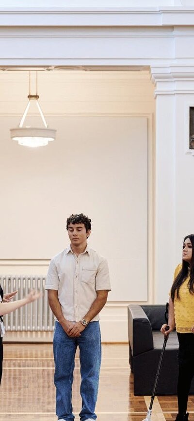 A group of people stand in King's Hall