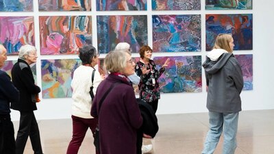 our group in front of Emily Kam Kngwarray's colourful paintings