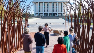 Tour guide Sita with tour group out the front of the National Library of Australia