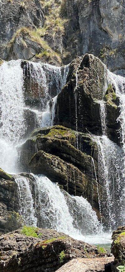 A waterfall leading into a pool of water.