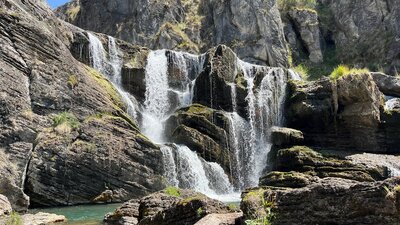 A waterfall leading into a pool of water.