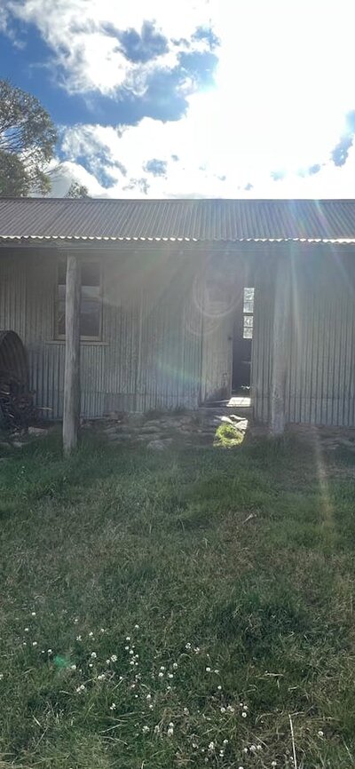 A hut with the sun setting being it.