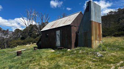 An iron hut surrounded by green grass.