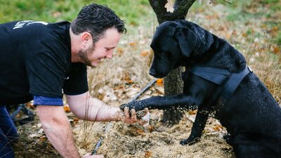 Farmer with his dog and truffle