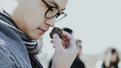 Asian man smelling a truffle