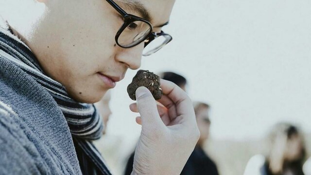 Discover the black gold that is truffle Asian man smelling a truffle