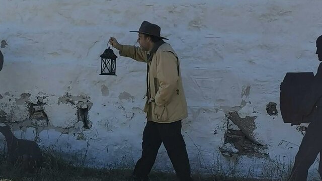 Man holding an oil lamp