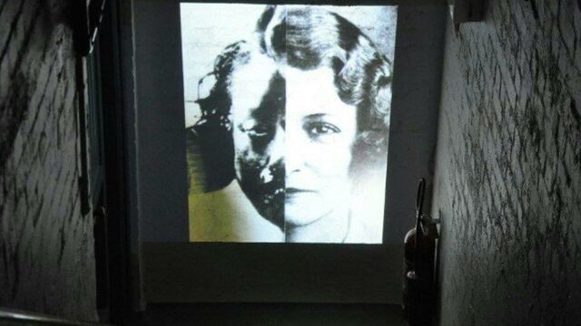 Black and white image of girl projected on a wall