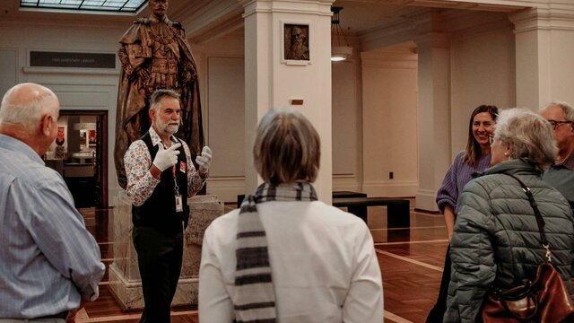 King's Hall - MoAD at Old Parliament House MoAD Experience Officer with a group of people gathered in King's Hall