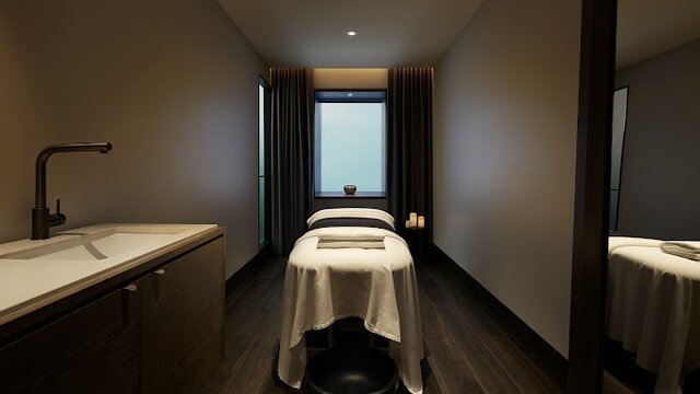 A massage bed and basin at a stylish and modern day spa. 