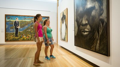 © Sean Davey Two women stand and look at a large painted portrait at the National Portrait Gallery | © Sean Davey