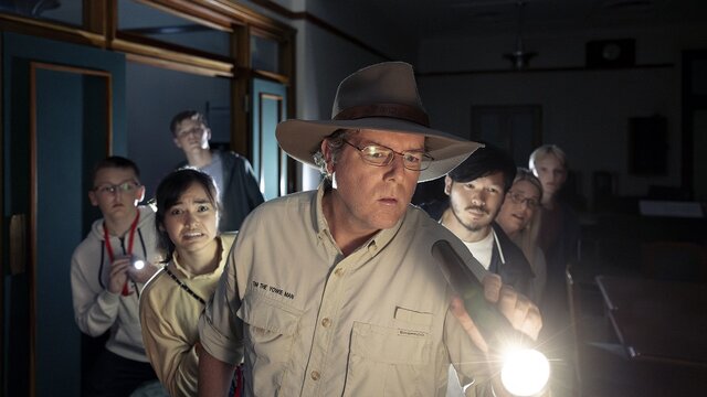 Tim leading a tour with a flashlight in hand