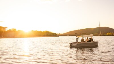 An electric picnic boat on the water.