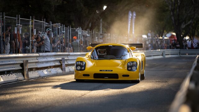 A yellow sports car on the road.