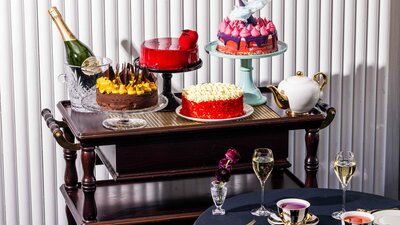 Various colourful cakes on a trolley.