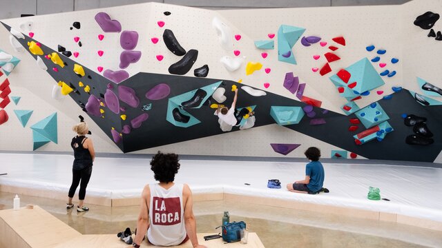 Participants climbing on a bouldering wall