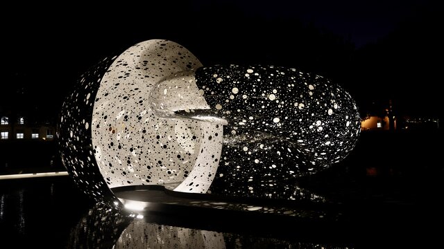 A large outdoor sculpture shown at night time