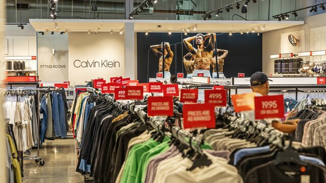 Racks of clothing in an outlet centre shop