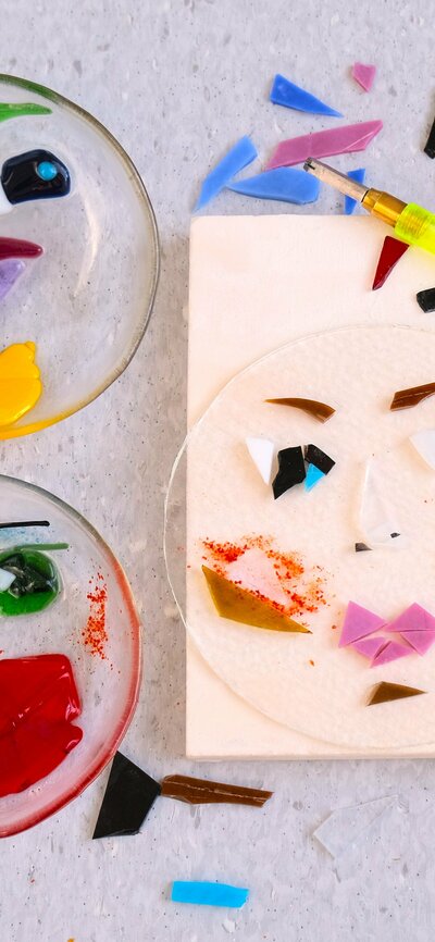 Three glass bowls with faces