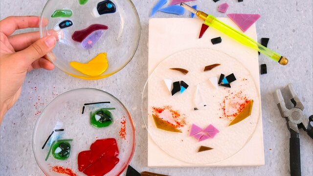 Three glass bowls with faces