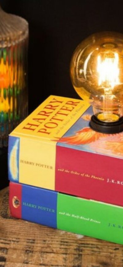A stack of books with a light bulb coming from the top