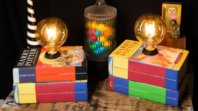 A stack of books with a light bulb coming from the top