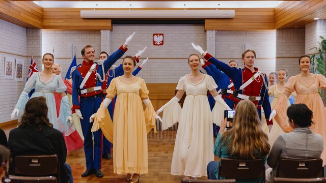 A group of performers posing together in costume