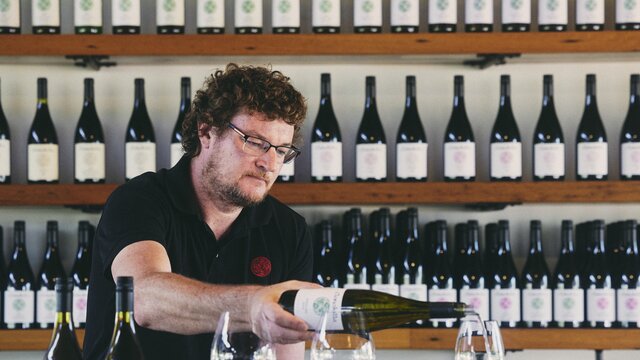 Clonakilla cellar door Man pouring a glass of wine at Clonakilla cellar door