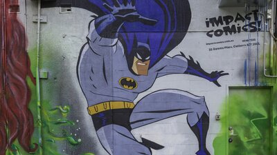 Artwork of a superhero on a wall in the city centre